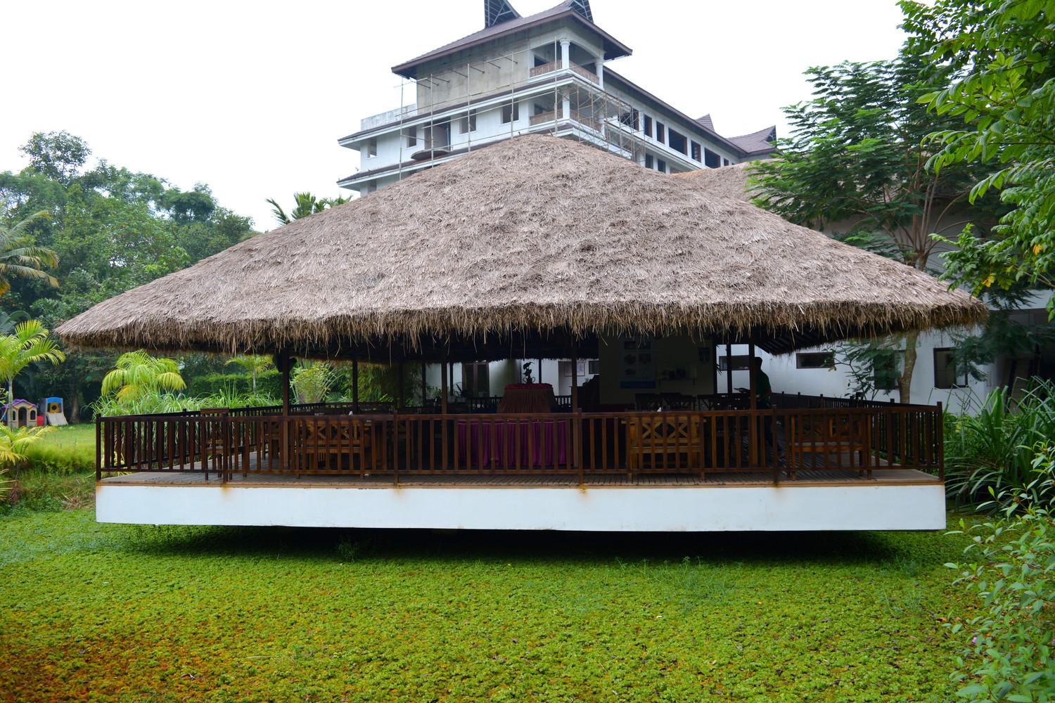 A floating restaurant with a thatched roof