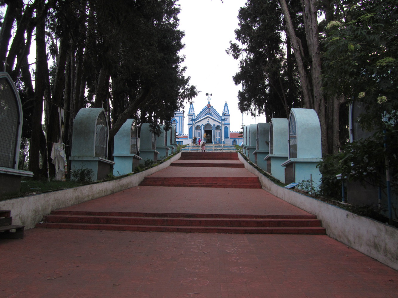 An ascending paved path leading to a church