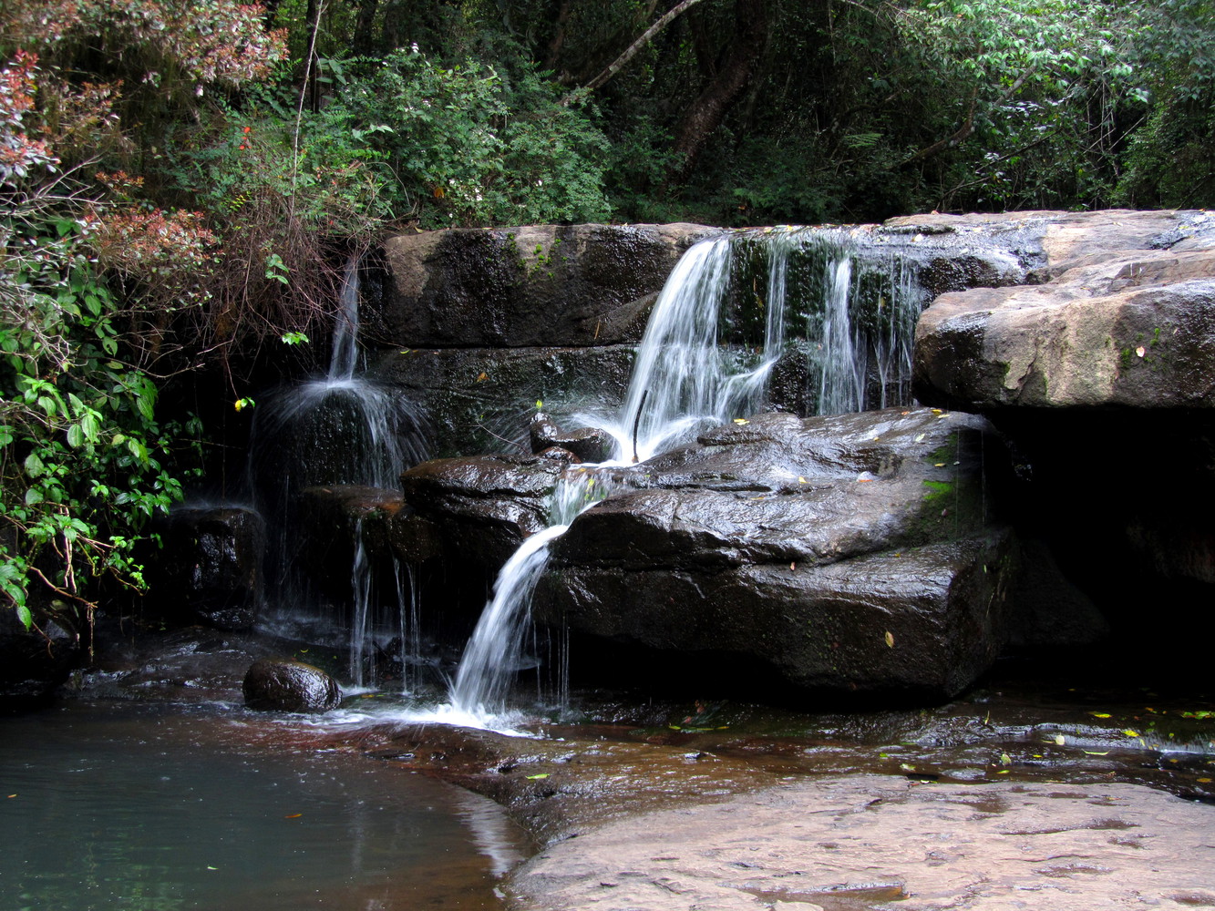 A waterfall descending a series of two rock steps