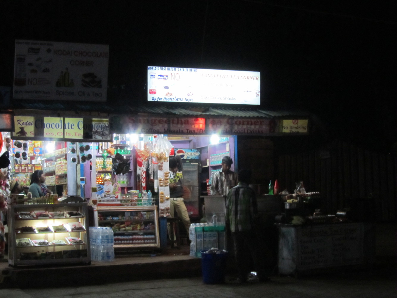 A tea shop named Sangeetha Tea Corner beside a chocolate shop named Kodai Chocolate Corner