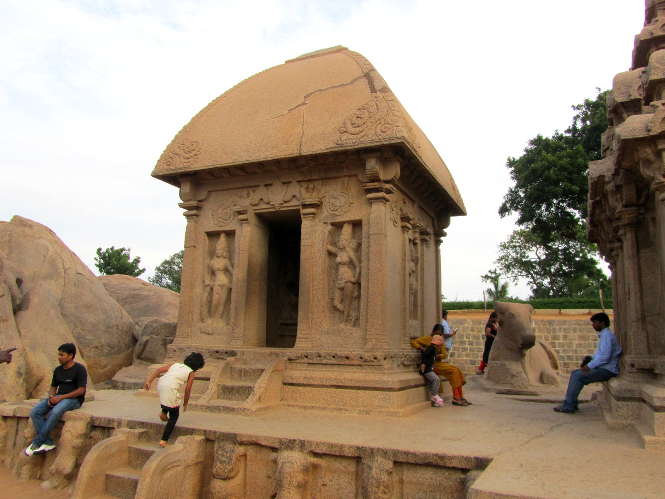 A monolithic granite monument known as Draupadi Ratha that resembles a village hut with thatched roof
